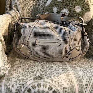 B. Makowsky laser cut, perforated hobo bag. Off-white.